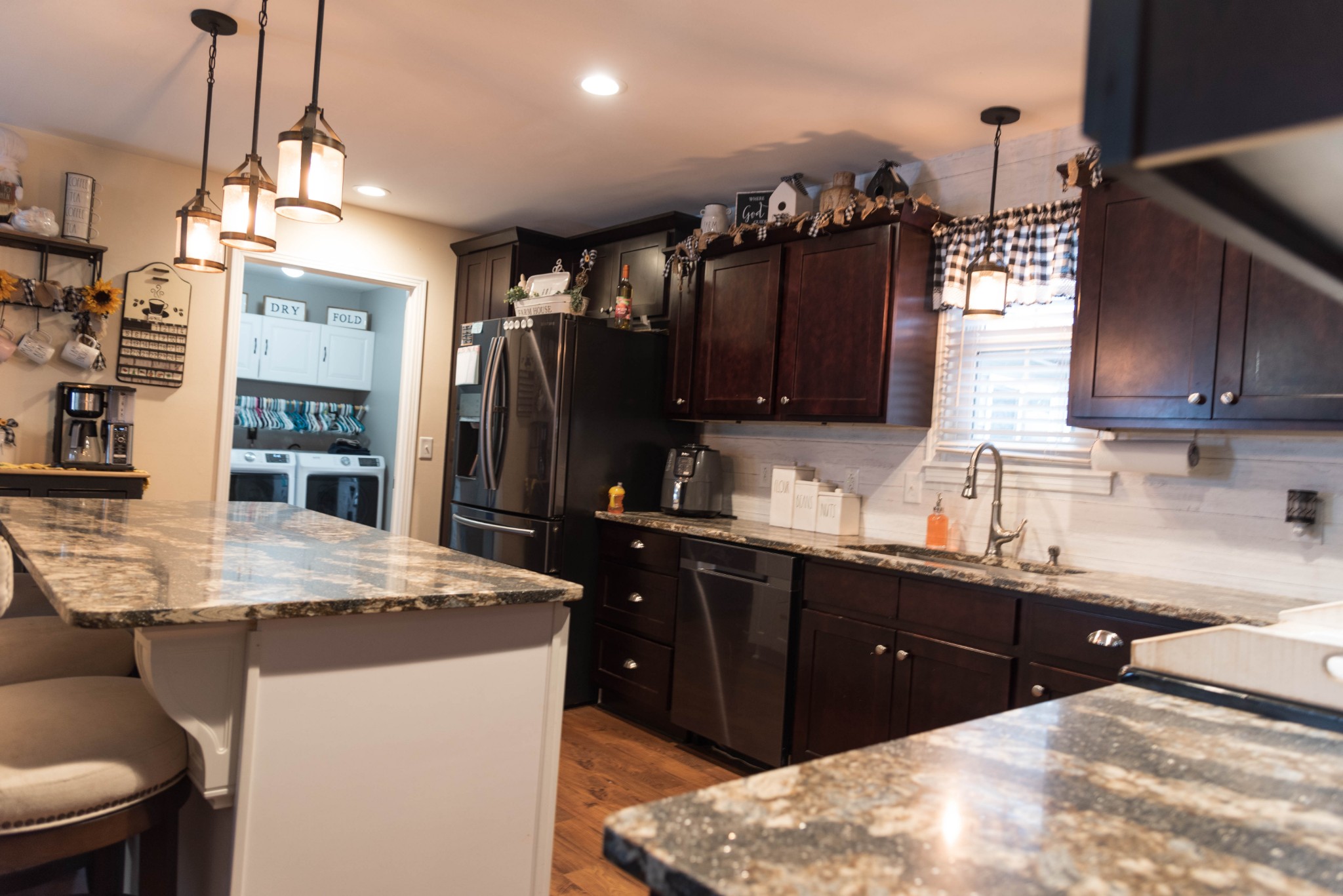 105 Biggs Road Cottontown, TN 37048 - Photo 9 of 40 a kitchen with stainless steel appliances kitchen island granite countertop a sink refrigerator and cabinets