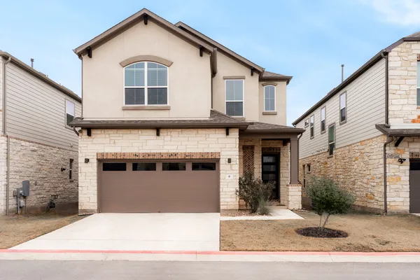 a front view of a house with garage