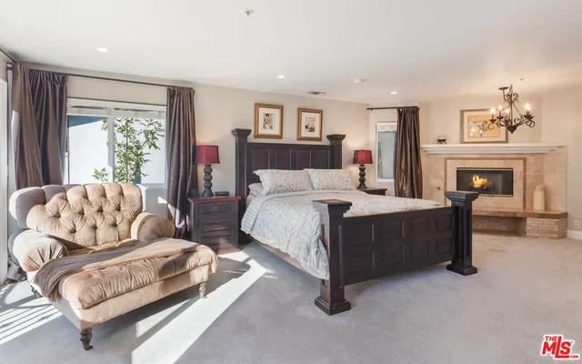 a spacious bedroom with a bed and a couch