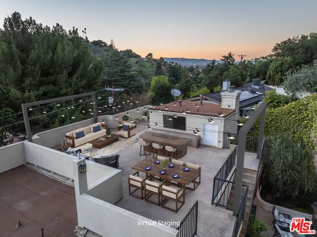a view of a terrace with couches and wooden floor