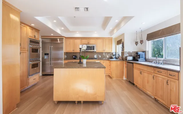 a large kitchen with stainless steel appliances kitchen island granite countertop a large counter top stainless steel appliances and cabinets