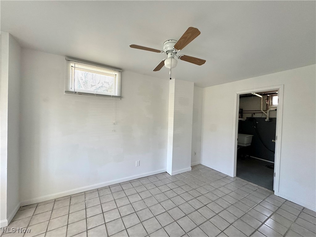 8961 Herbert Road Canfield, OH 44406 - Photo 22 of 26 Spare room with baseboards, ceiling fan, and light tile patterned flooring