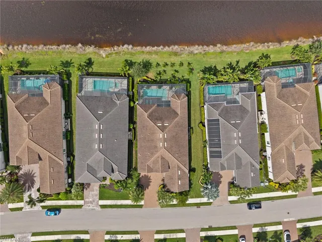 front view of a brick house with a yard