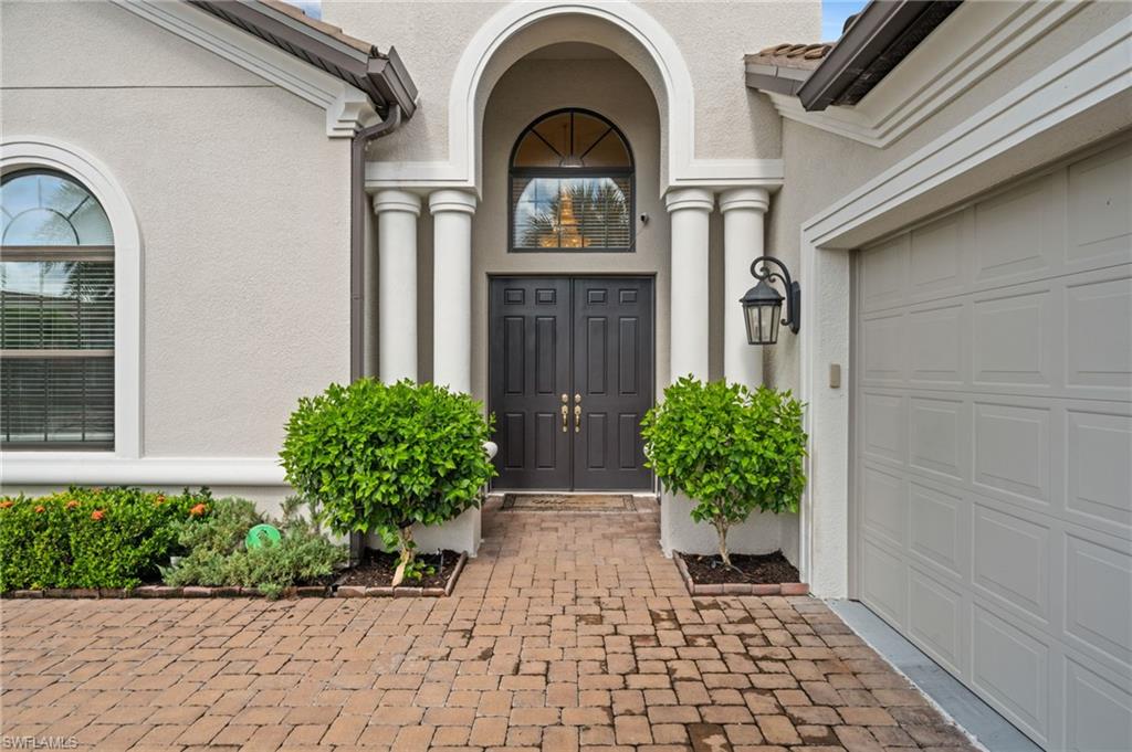 9509 Montelanico Loop Naples, FL 34119 - Photo 15 of 50 a house view with a outdoor space