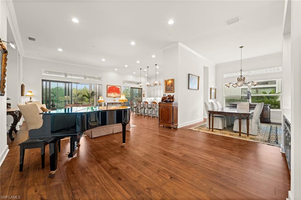 9509 Montelanico Loop Naples, FL 34119 - Photo 20 of 50 a living room with furniture and a wooden floor