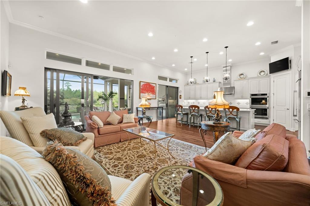 9509 Montelanico Loop Naples, FL 34119 - Photo 22 of 50 a living room with furniture and a large window