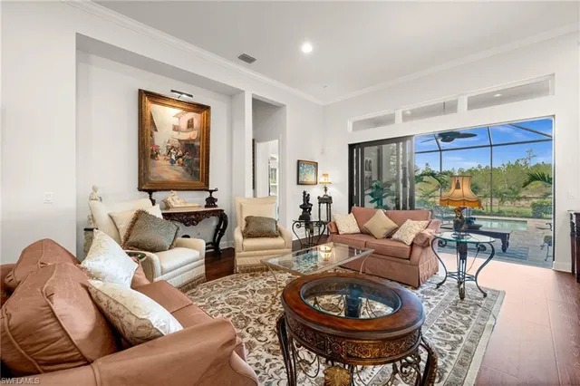a living room with furniture a rug and a large window