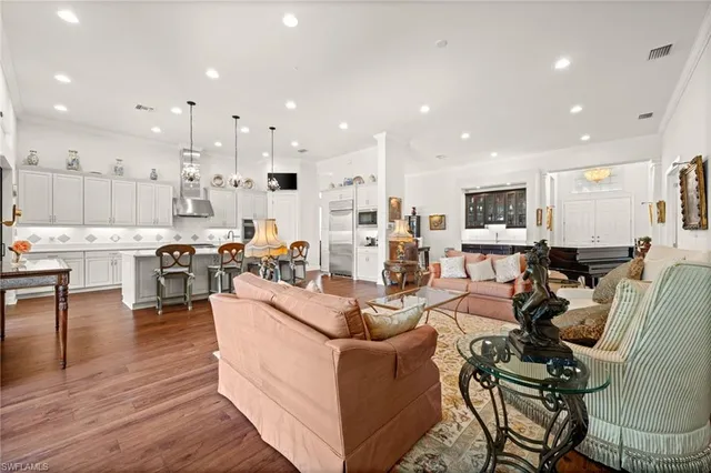 a living room with lots of furniture and kitchen view