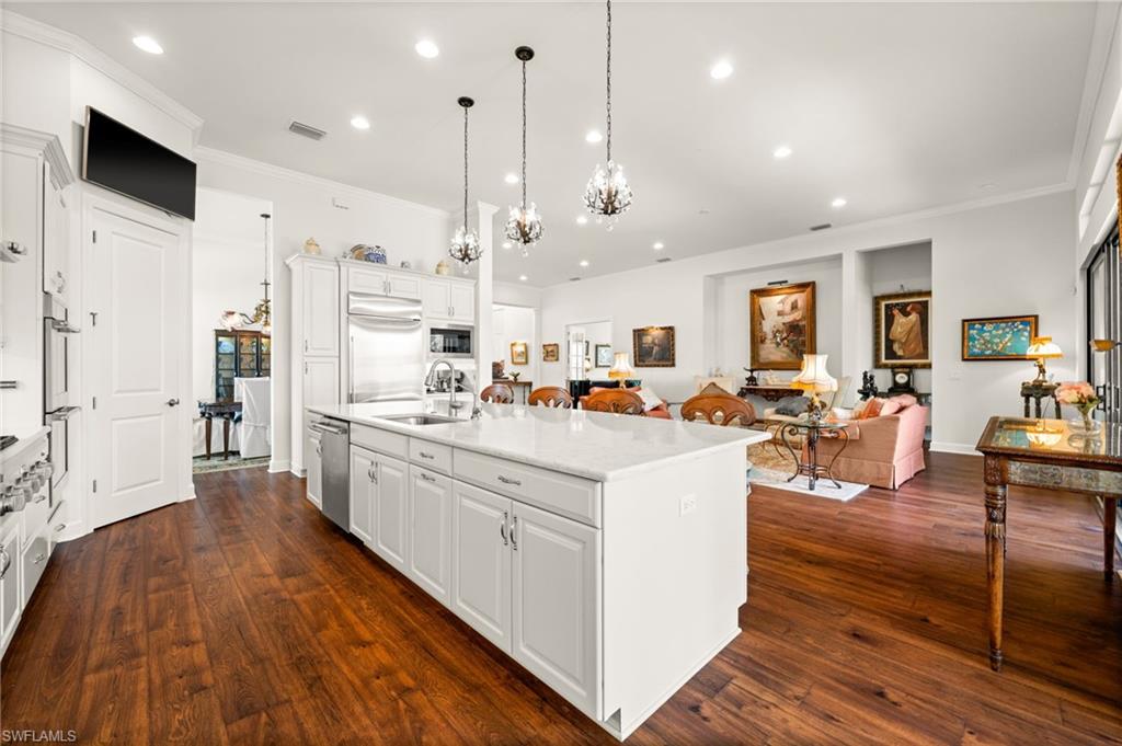 9509 Montelanico Loop Naples, FL 34119 - Photo 25 of 50 a large white kitchen with lots of counter space and stainless steel appliances