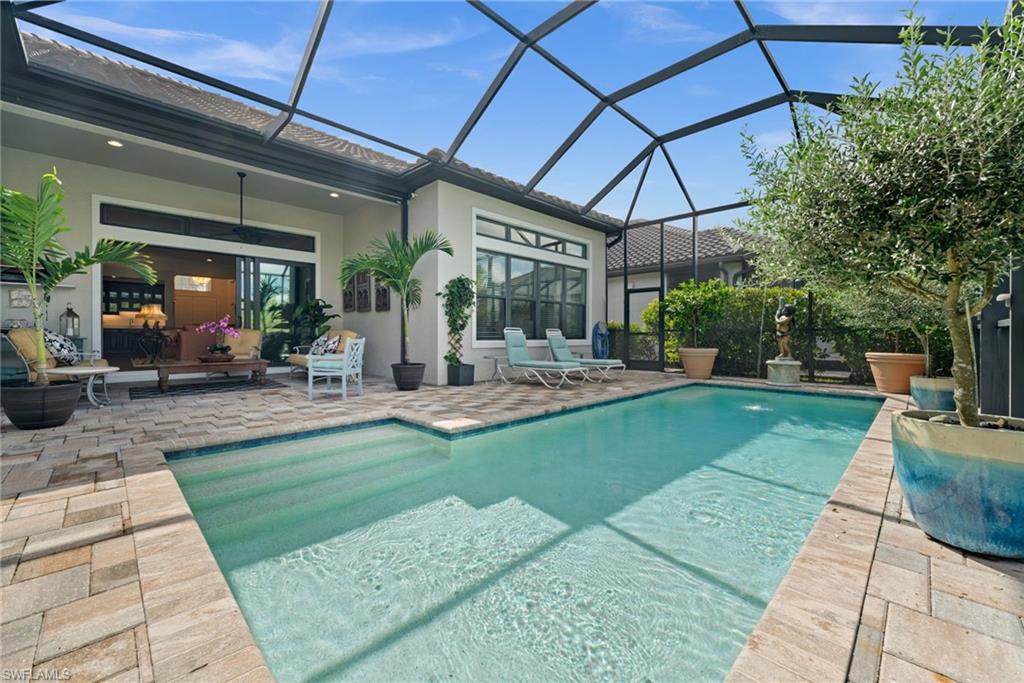 9509 Montelanico Loop Naples, FL 34119 - Photo 31 of 50 a view of a patio with a table and chairs
