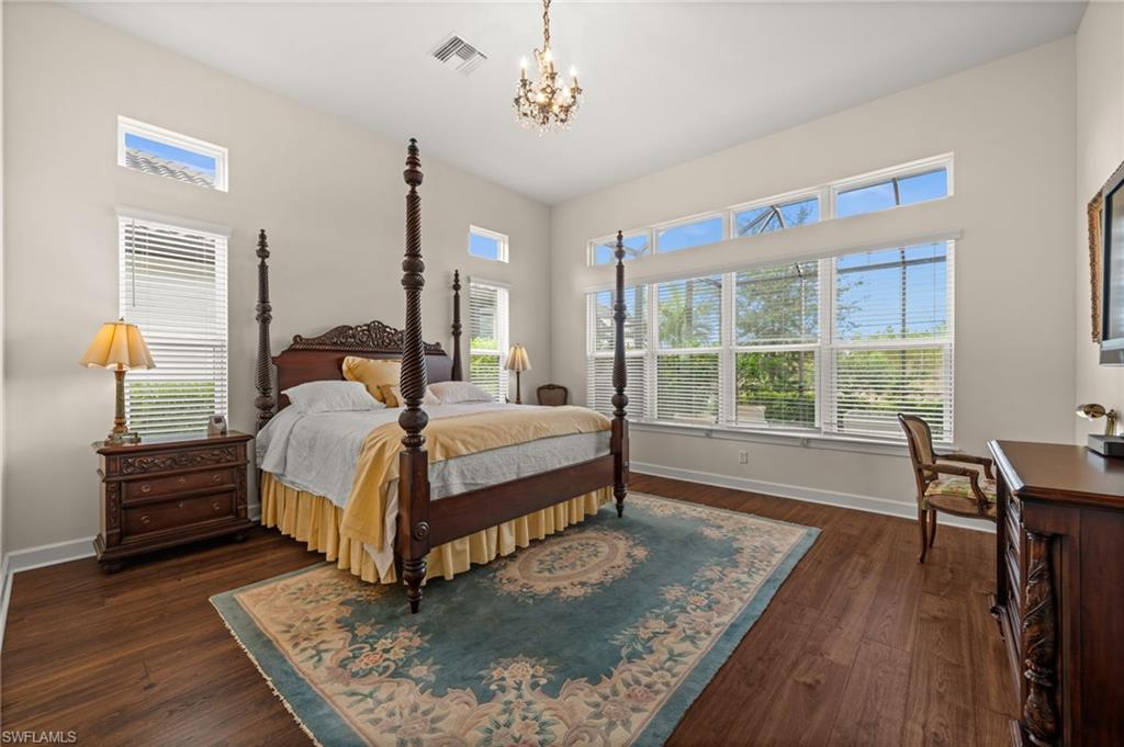 9509 Montelanico Loop Naples, FL 34119 - Photo 35 of 50 a bed sitting in a bedroom next to a window