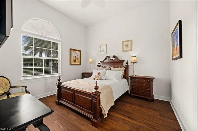 a large bed sitting in a bedroom next to a window with desk