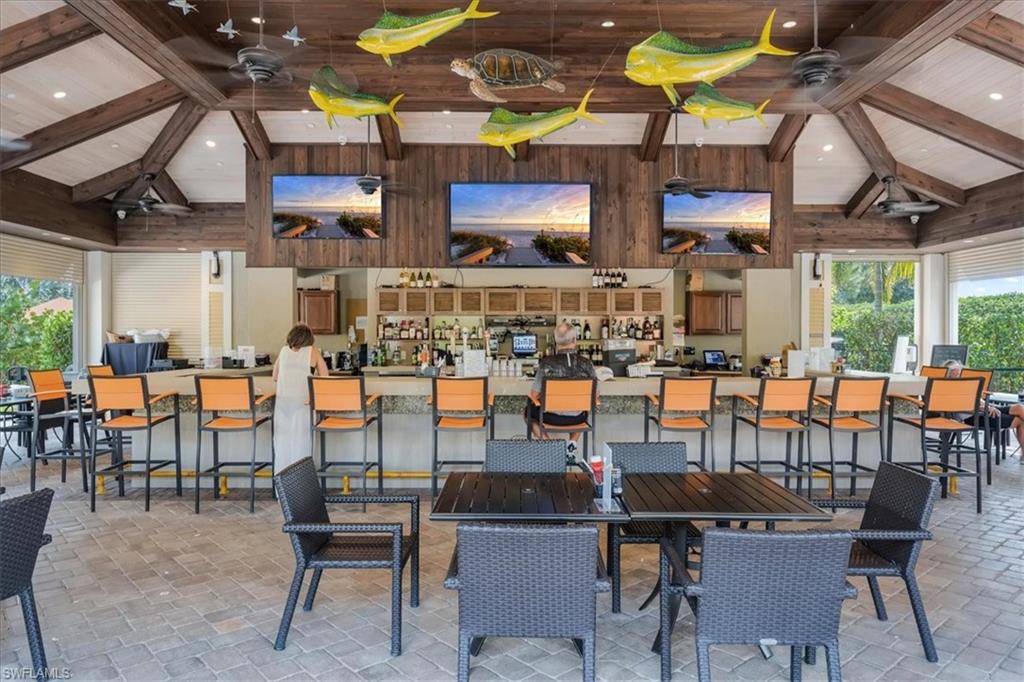 9509 Montelanico Loop Naples, FL 34119 - Photo 45 of 50 a group of people sitting outside of a restaurant