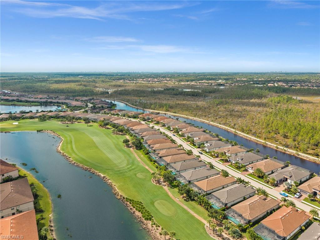 9509 Montelanico Loop Naples, FL 34119 - Photo 9 of 50 an aerial view of a city with a lake view