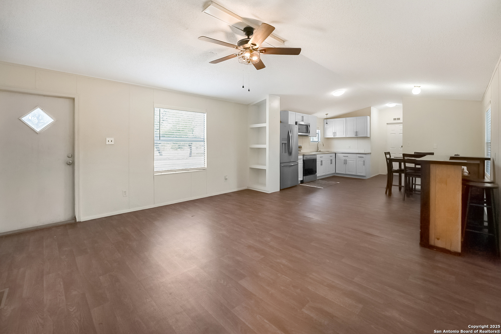 25335 Pleasanton Road San Antonio, TX 78264 - Photo 15 of 26 a view of a livingroom with furniture a ceiling fan and wooden floor