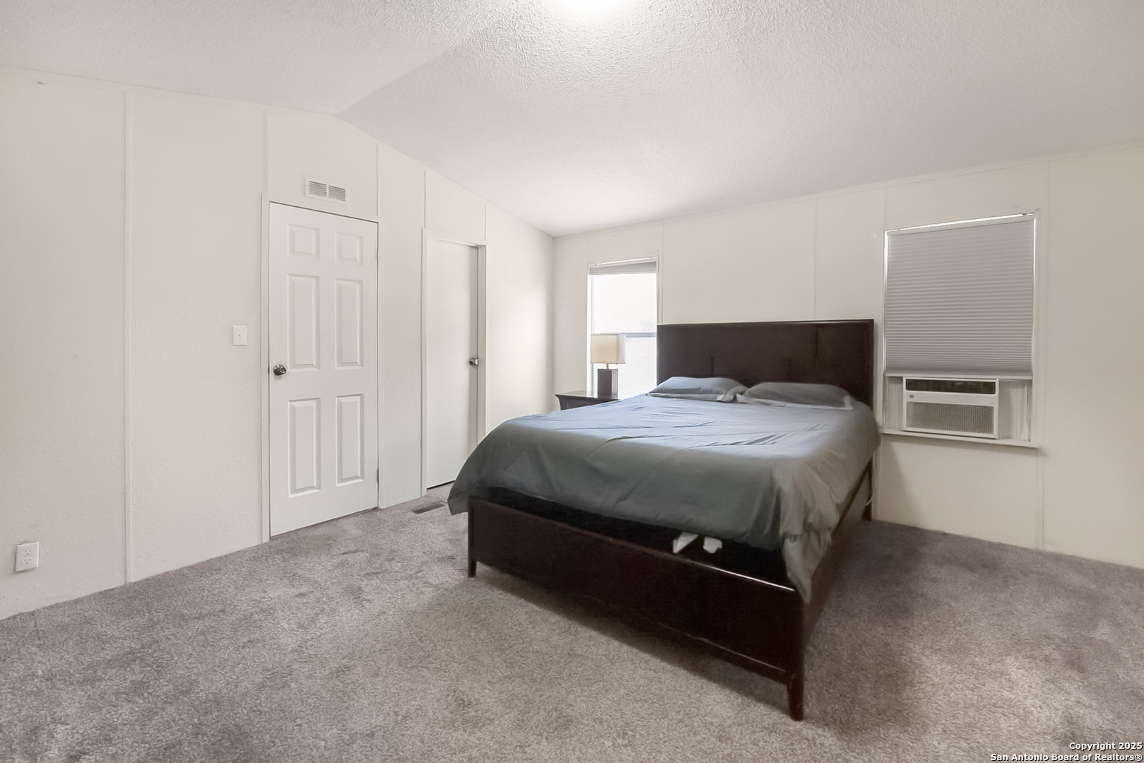 25335 Pleasanton Road San Antonio, TX 78264 - Photo 19 of 26 a spacious bedroom with a bed and a cabinets