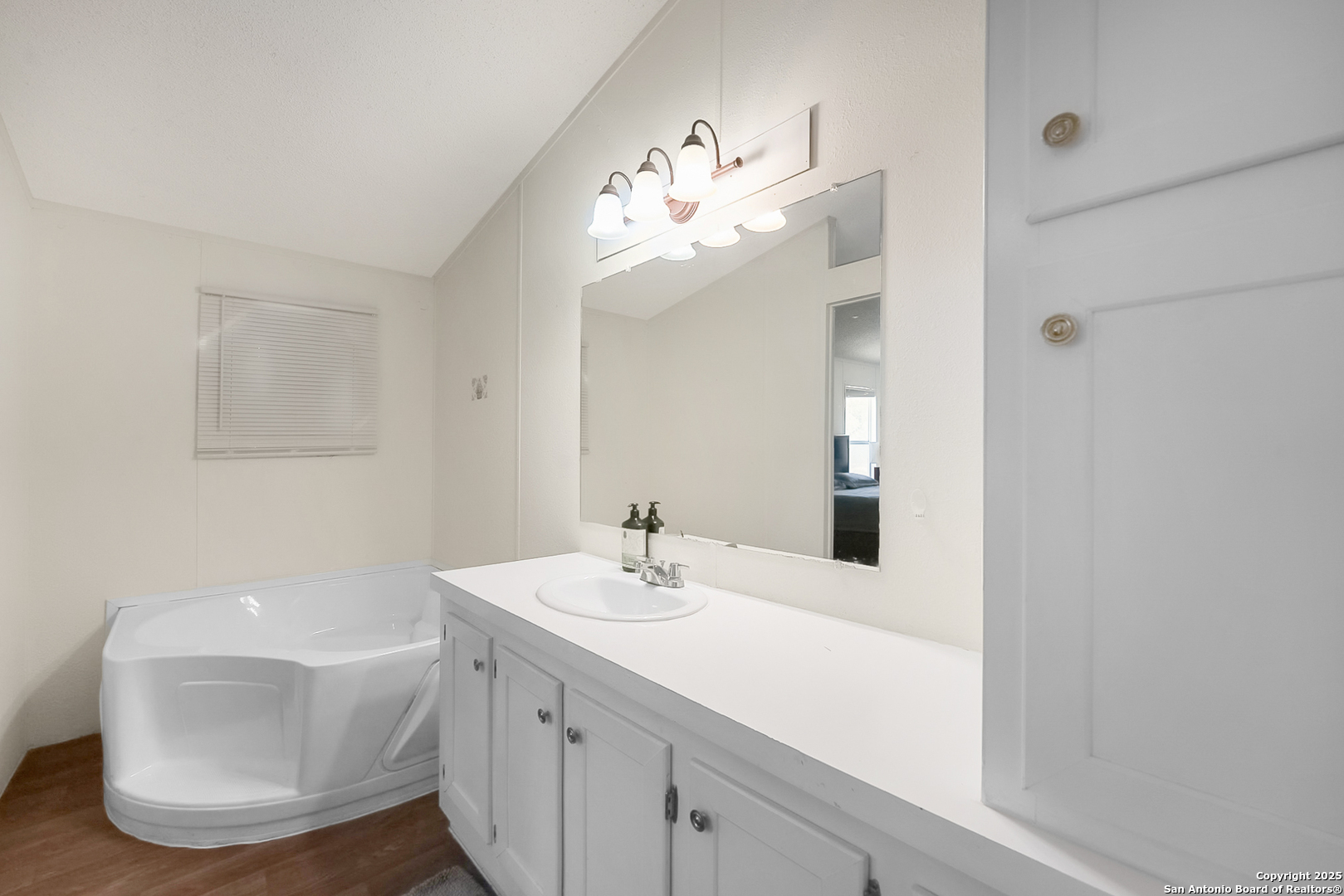 25335 Pleasanton Road San Antonio, TX 78264 - Photo 21 of 26 a bathroom with a sink a large mirror and vanity