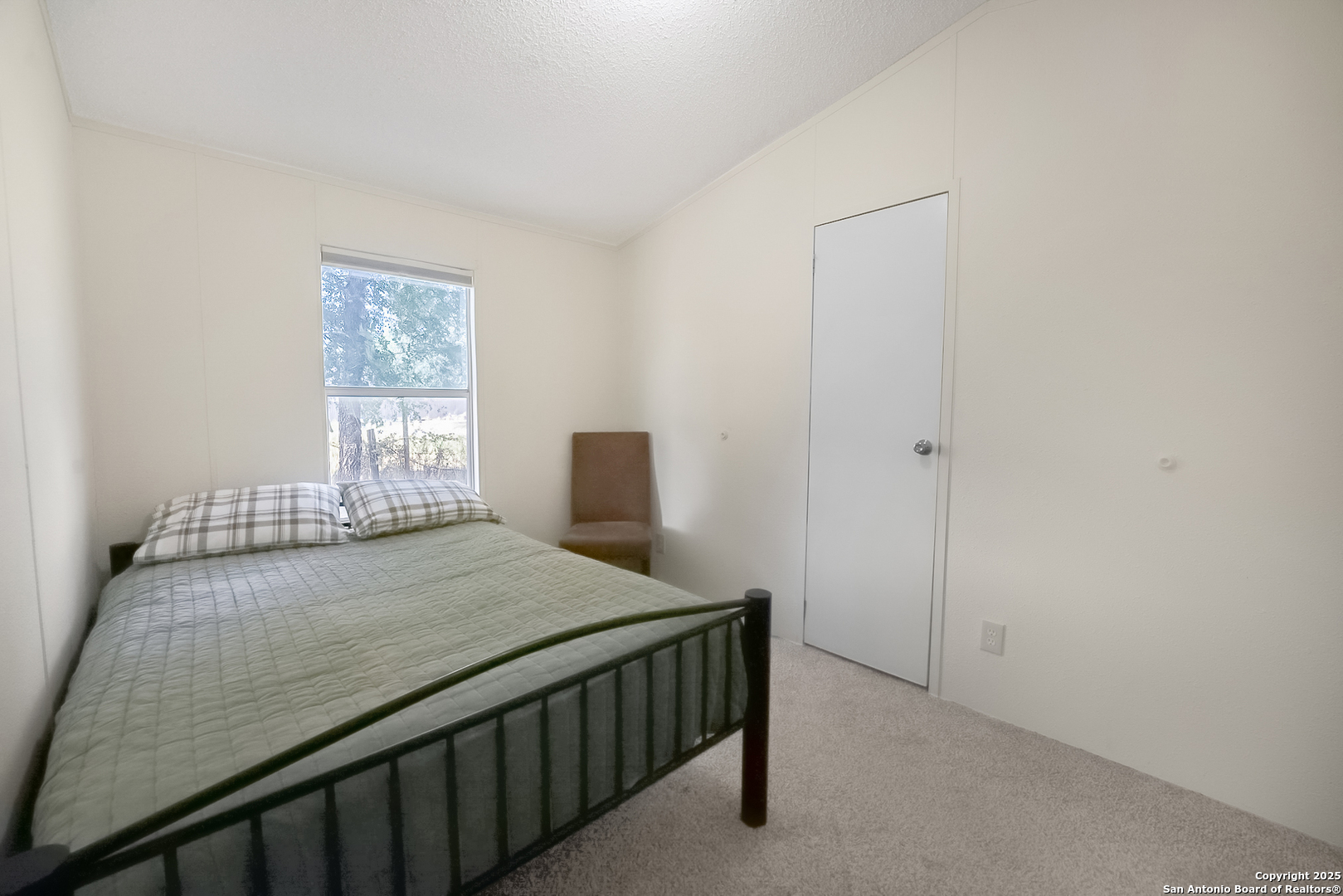 25335 Pleasanton Road San Antonio, TX 78264 - Photo 23 of 26 a bedroom with a bed and a window