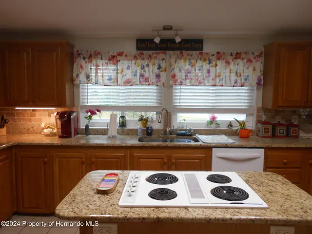 a kitchen with a refrigerator and a stove