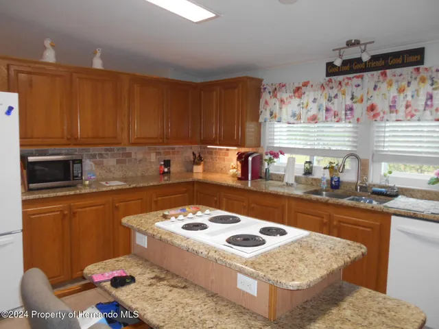 a kitchen with a stove a sink and a refrigerator
