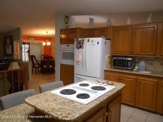 a kitchen with a sink stove and refrigerator