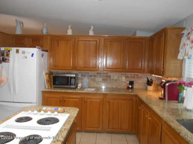 a kitchen with a sink a stove and a refrigerator