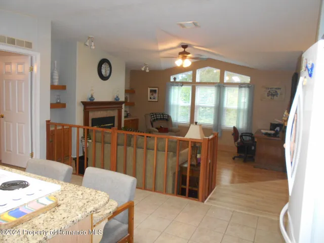 a living room with furniture a fireplace and a large mirror