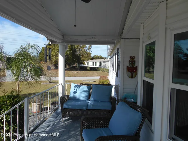 a balcony with furniture and a potted plant