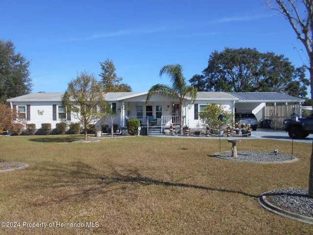 a swimming pool view with a seating space and a garden view