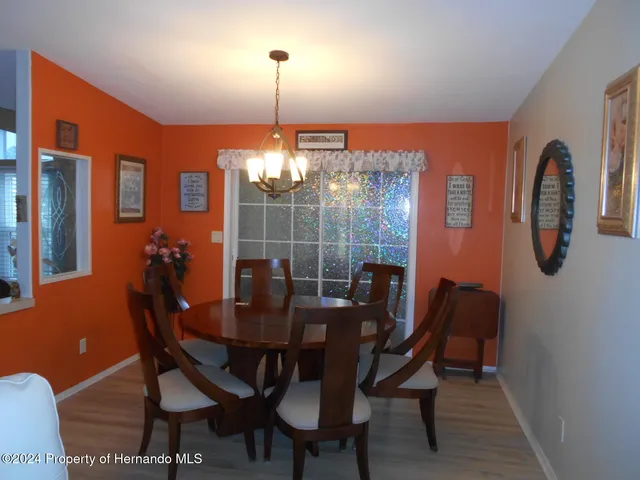 a view of a dining room with furniture and chandelier