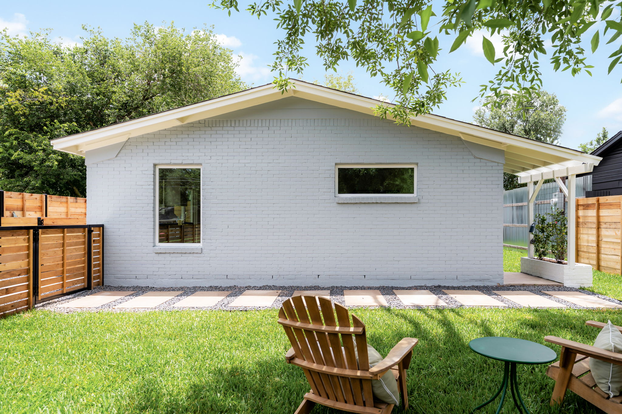 4902 Blueberry Trail, Unit 1 Austin, TX 78723 - Photo 29 of 30 a backyard of a house with table and chairs