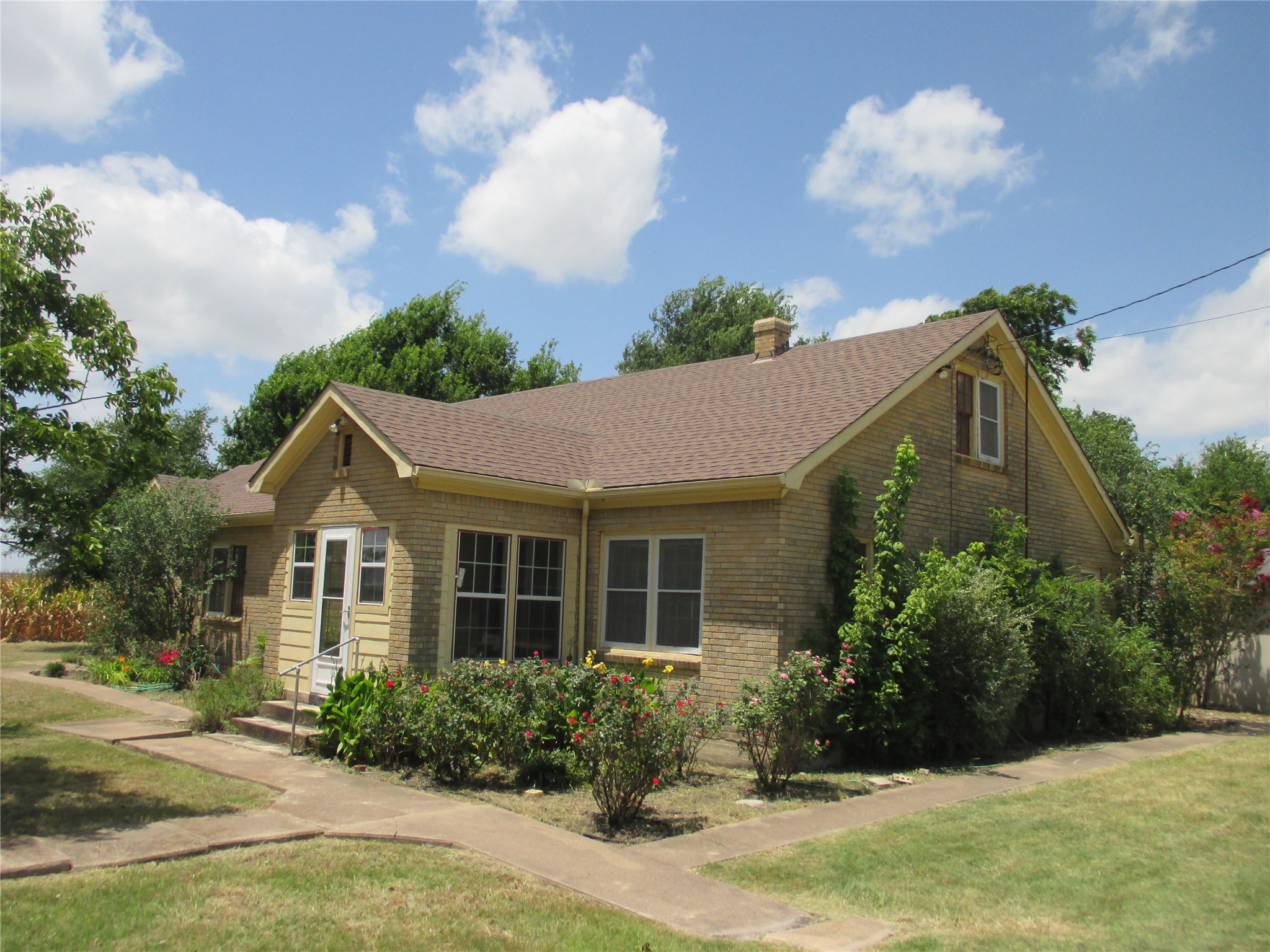 12610 Pecan School Road Bartlett, TX 76511 - Photo 3 of 21 A classic brick exterior with a welcoming entryway, nestled amidst mature landscaping and a manicured lawn.