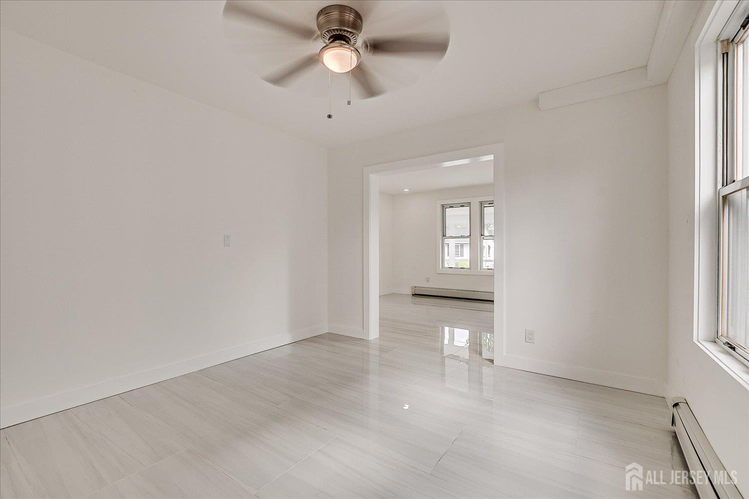 37 Summit Avenue Fords, NJ 08863 - Photo 11 of 28 an empty room with chandelier fan and windows