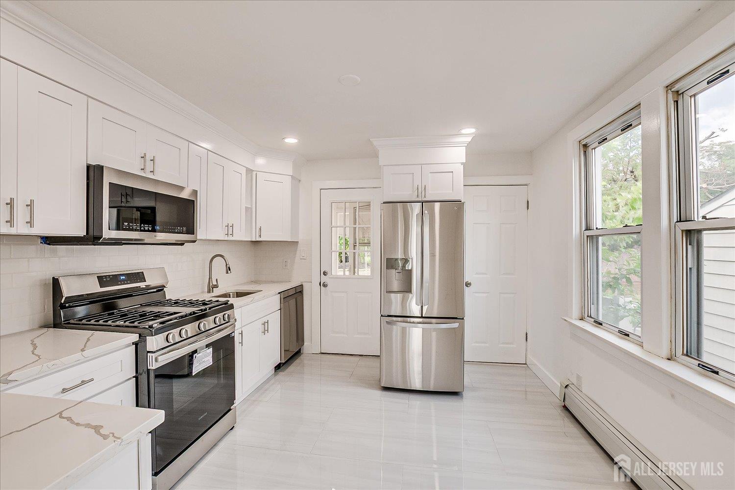37 Summit Avenue Fords, NJ 08863 - Photo 13 of 28 a kitchen with stainless steel appliances a refrigerator stove and microwave