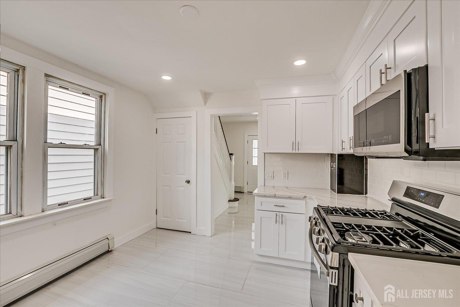 37 Summit Avenue Fords, NJ 08863 - Photo 16 of 28 a kitchen with stainless steel appliances granite countertop a stove a sink and a refrigerator