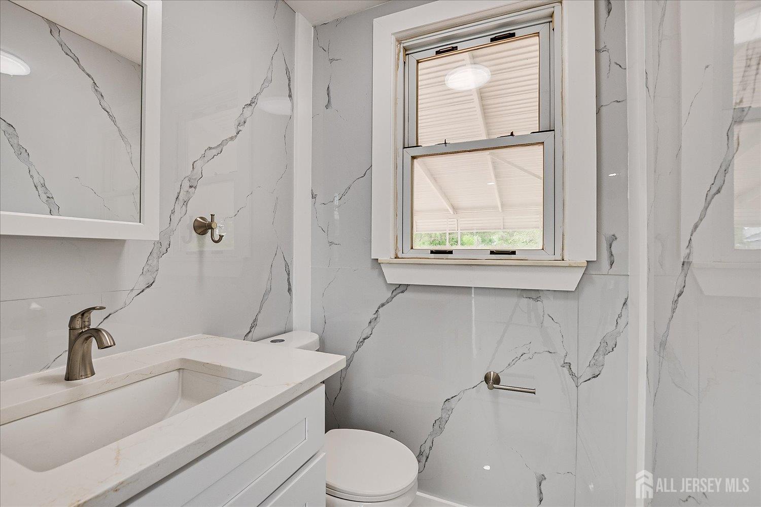 37 Summit Avenue Fords, NJ 08863 - Photo 17 of 28 a bathroom with a toilet sink and window