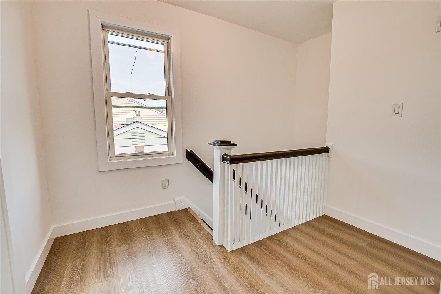 37 Summit Avenue Fords, NJ 08863 - Photo 19 of 28 a view of an empty room with wooden floor and a window
