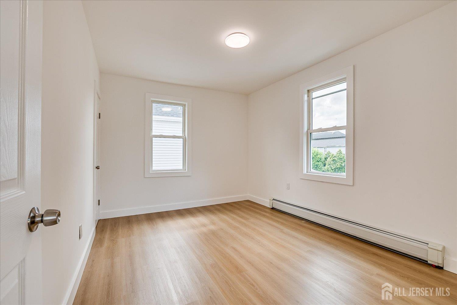 37 Summit Avenue Fords, NJ 08863 - Photo 20 of 28 an empty room with a window and wooden floor