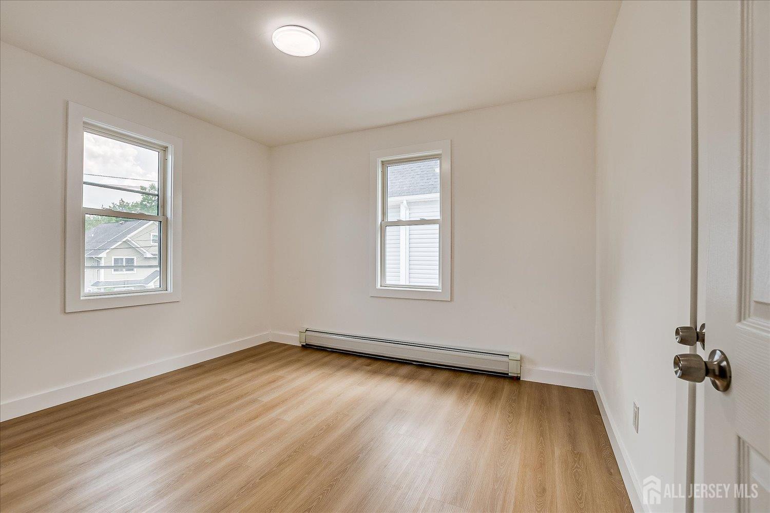 37 Summit Avenue Fords, NJ 08863 - Photo 22 of 28 an empty room with wooden floor and windows
