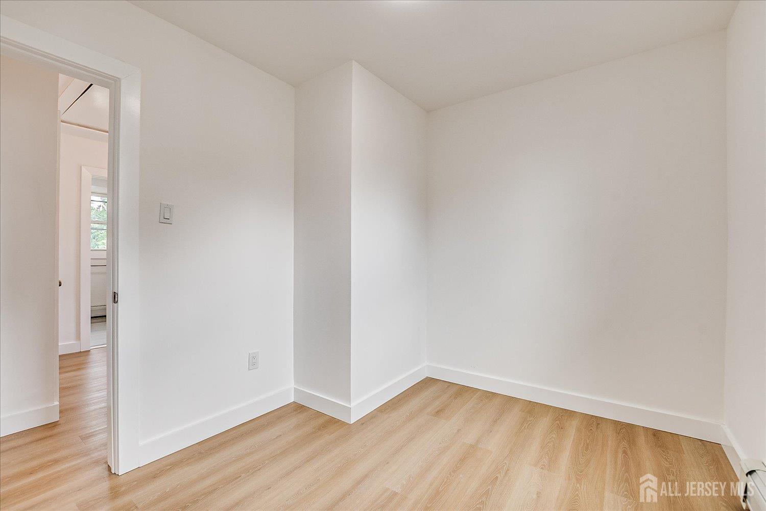 37 Summit Avenue Fords, NJ 08863 - Photo 26 of 28 a view of an empty room with wooden floor and a window