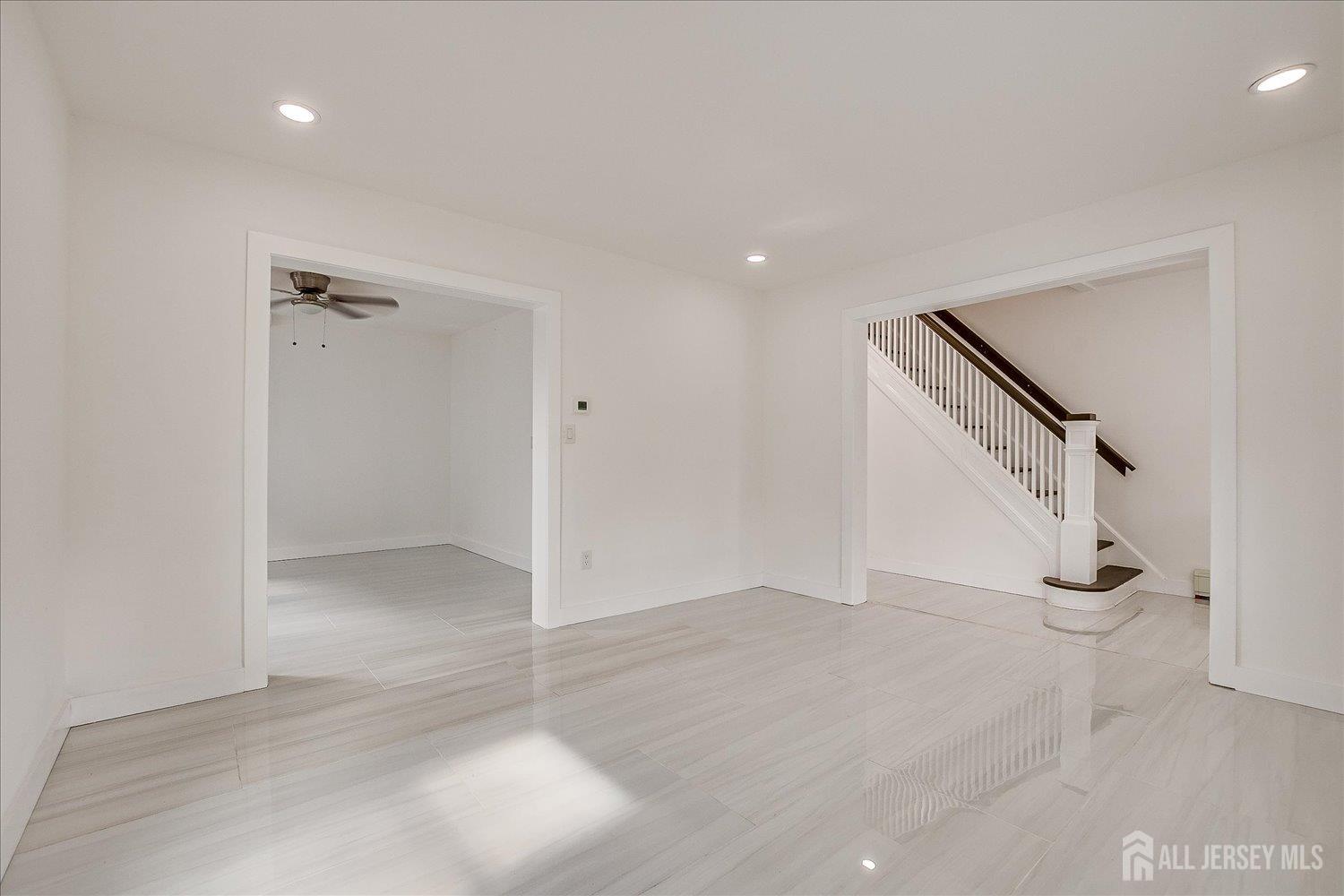 37 Summit Avenue Fords, NJ 08863 - Photo 9 of 28 wooden floor in an empty room with a staircase