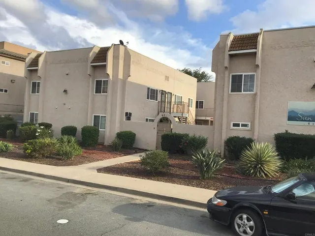 a front view of a house with parking space
