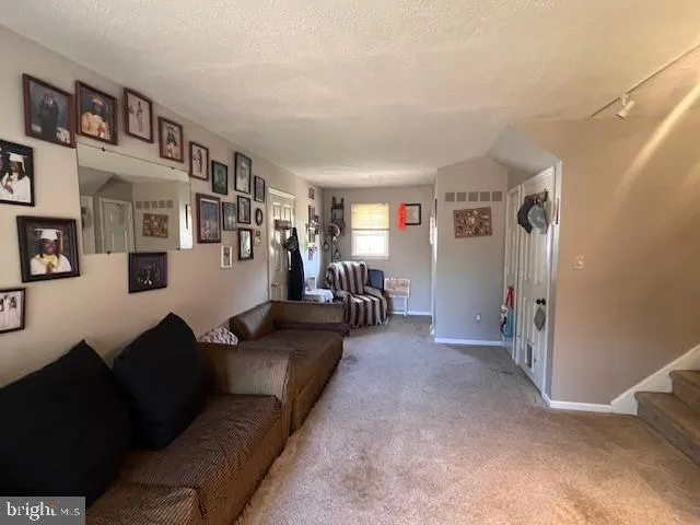 a living room with furniture and a bookshelf