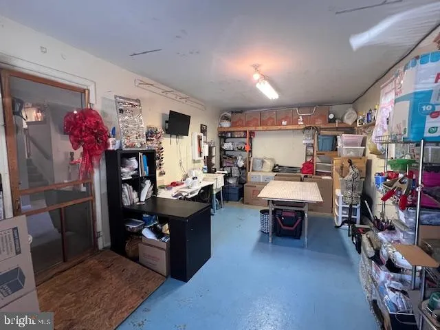 a living room with lots of furniture and clutter