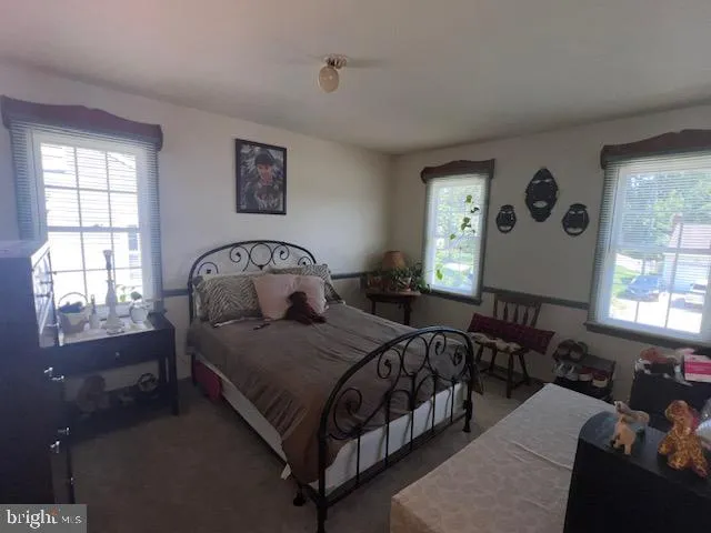 a bedroom with a bed couch and window