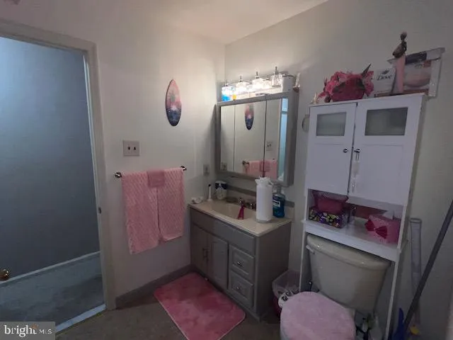a bathroom with a sink vanity mirror and toilet