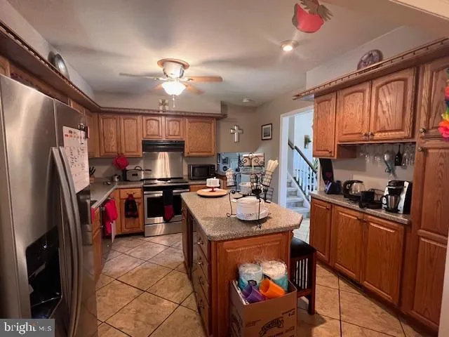 a kitchen with a refrigerator a sink dishwasher a stove and a refrigerator