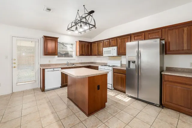a kitchen with cabinets stainless steel appliances and a counter top space