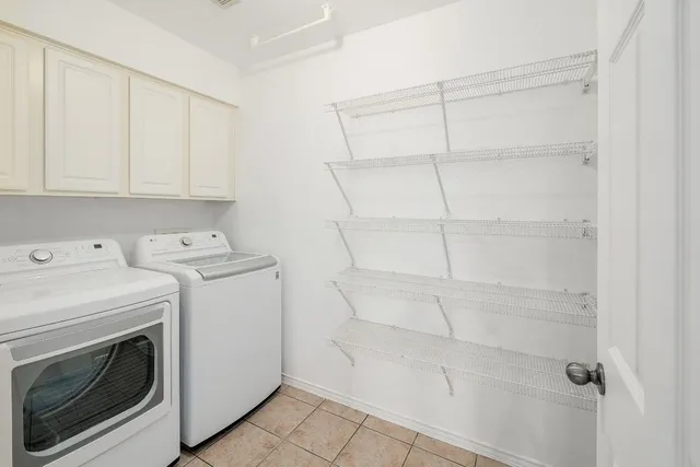 a view of washer and dryer with kitchen in the background