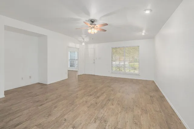 wooden floor in an empty room with a window